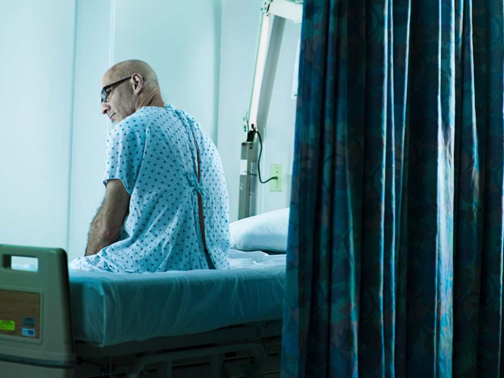 Veteran in Glasses Waiting on VA Bed