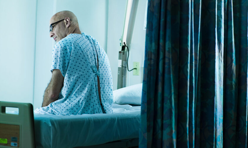 Veteran in Glasses Waiting on VA Bed