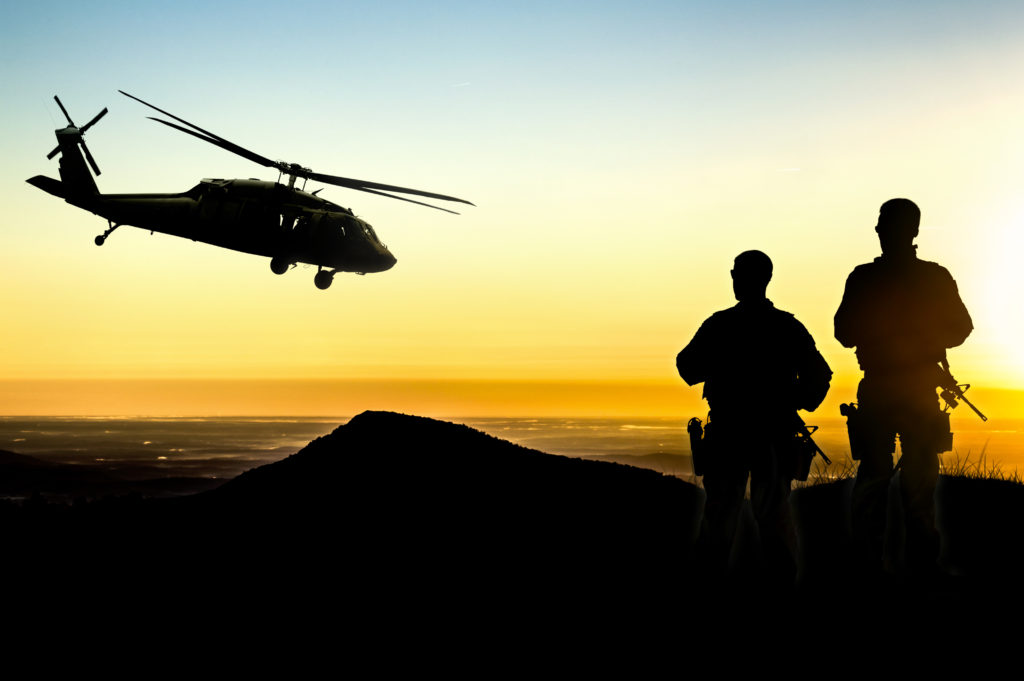 US Military Helicopter with Soldiers Silhouette in Sunset