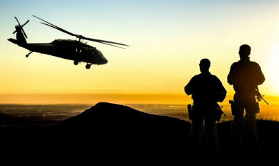 US Military Helicopter with Soldiers Silhouette in Sunset