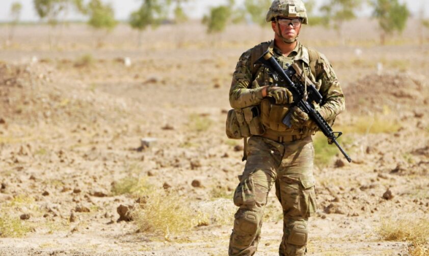 Soldier with gun patrolling Afghanistan