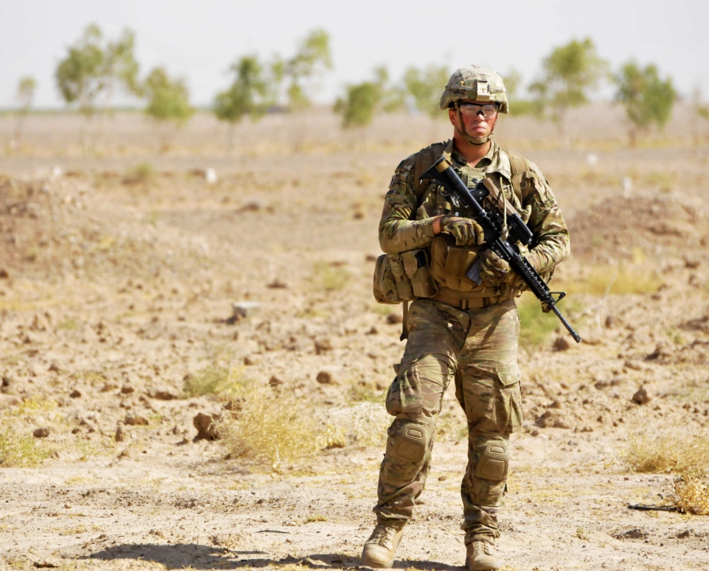 Soldier with gun patrolling Afghanistan