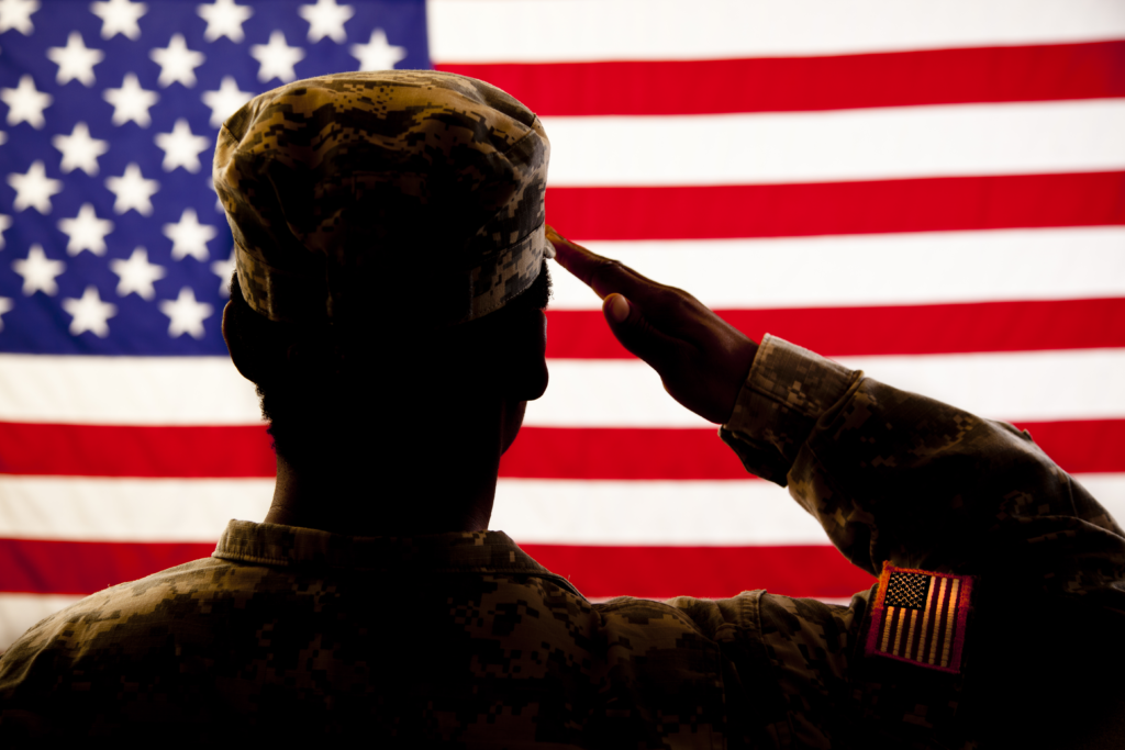 Silhouetted Soldier Saluting American Flag