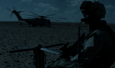 Soldier guarding helicopter background