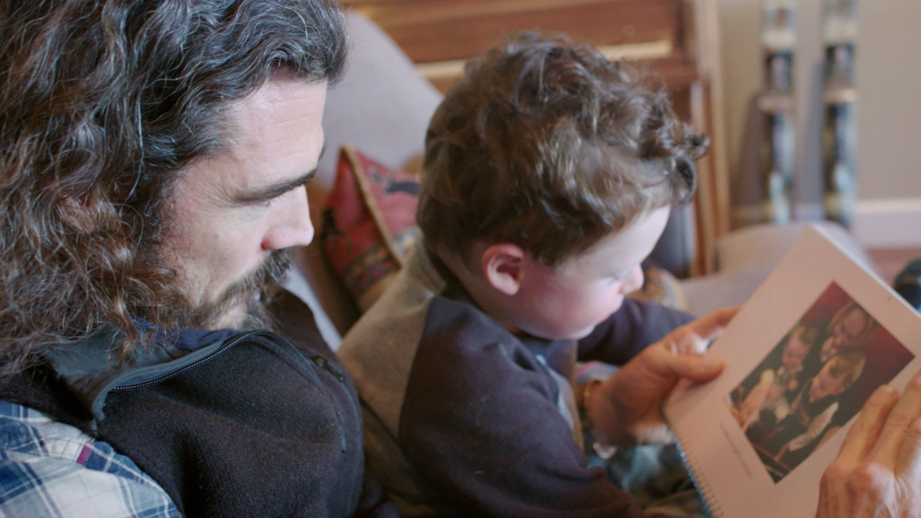 Veteran Showing Son Photo of their deployment