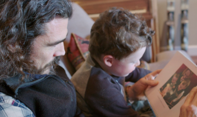 Veteran Showing Son Photo of their deployment