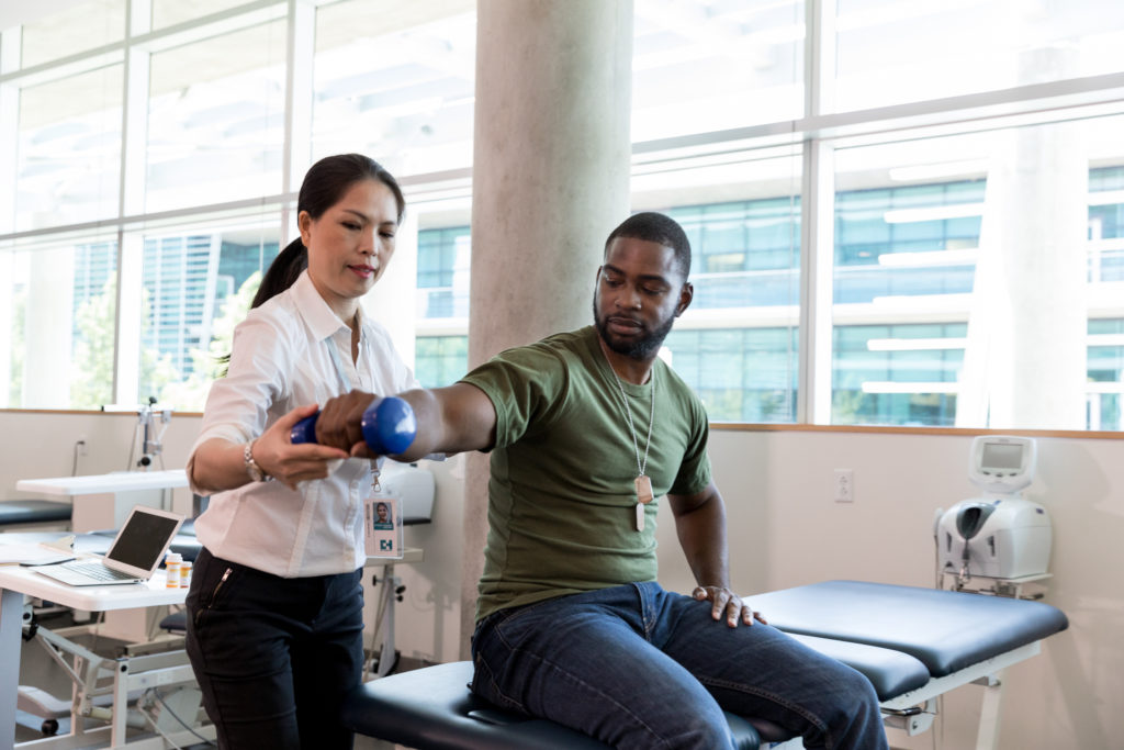 Doctor taking Veteran's blood pressure