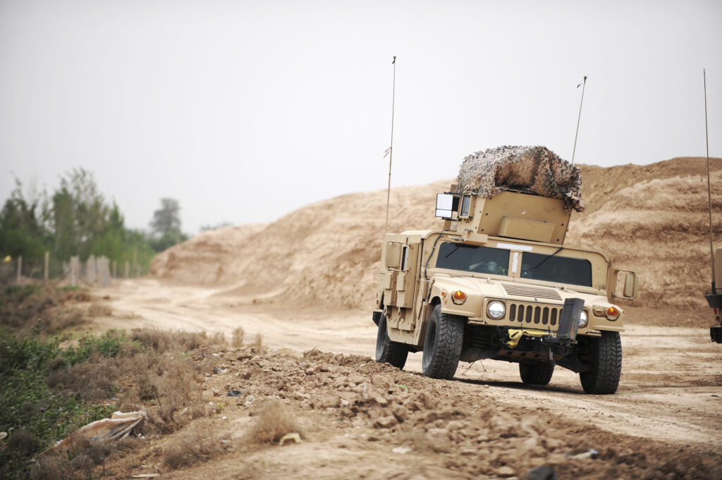 American Military Humvee Driving Down Desert Road