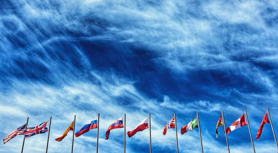 World Flags flying with Turbulent Clouds in Background